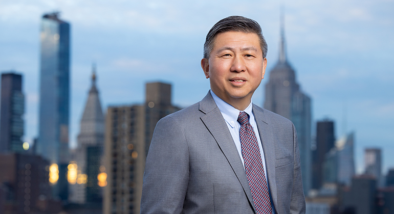 James C. Tsai with city skyline in background